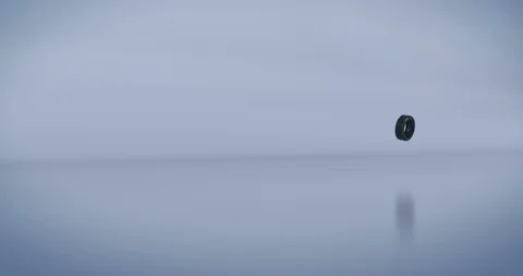 Old tyre spinning, hitting a small group of used car tyres Stock Footage 115168960