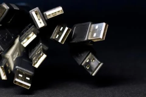 Old USB plug cable isolated on black background. Stock Photos