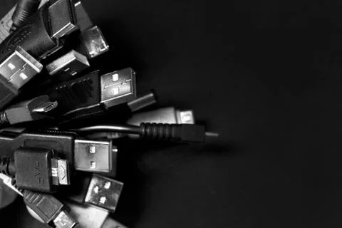 Old USB plug cable isolated on black background. Stock Photos