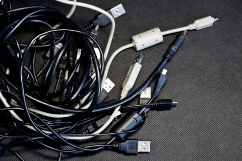 Old USB plug cable isolated on black background. Stock Photos