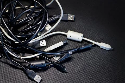 Old USB plug cable isolated on black background. Stock Photos