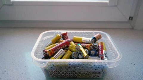Old used batteries fall into the recycling bin. Slow motion 库存影片 221852162
