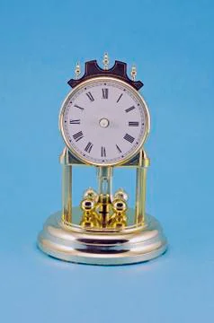 Old used clock on blue background Stock Photos