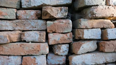 Old used construction bricks in a big stack in  harsh sunlight Stock Footage 161971146