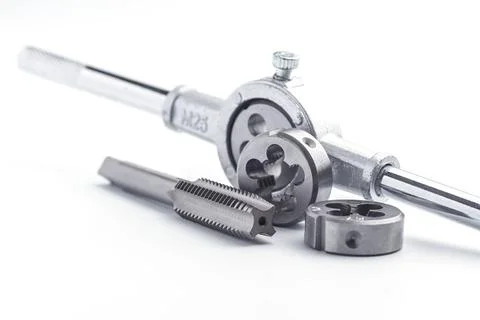Old used kit for cutting an external thread isolated on white background. tap Stock Photos