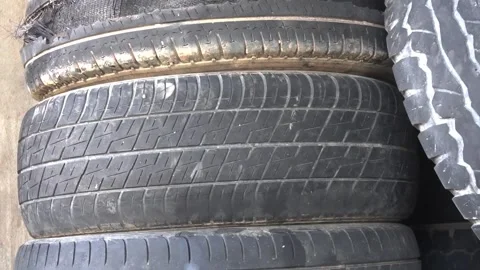 Old used worn car and truck wheels tyres pile Stock Footage 168575819