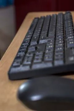 A old useful black keyboard with full of dust Stock Photos