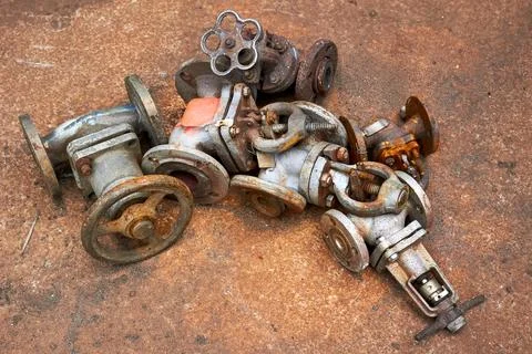 Old valves taps shutoff flaps vents of chemical production dismantled. Concep Stock Photos