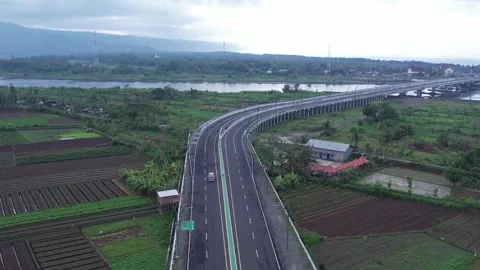 An old van crosses a long bridge with a beautiful landscape Stock Footage 310775017