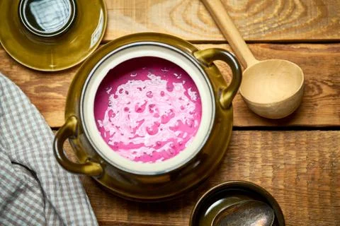 Old vase with  cold beetroot soup and spoon on rustic wooden table Stock Photos
