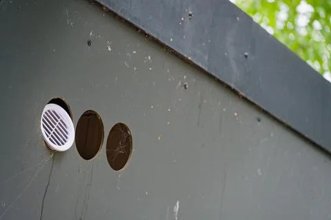 Old vent block with three round openings missing grilles Stock Photos