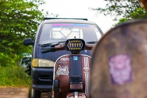 Old Vespas parked on the side of the road Stock Photos