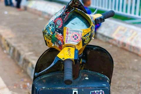 Old Vespas parked on the side of the road Stock Photos
