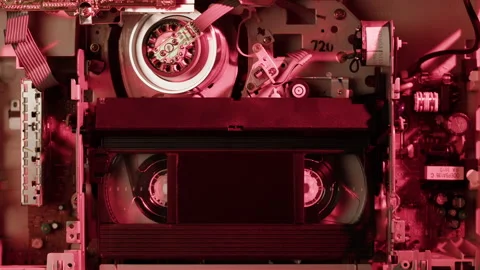 Old video recorder inside close-up, VHS. Retro player in neon red light, vintage 库存影片 205906174