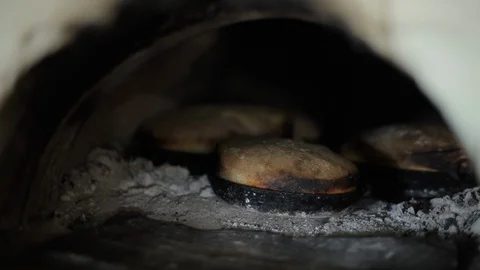 Old village oven, rustic bread is baked, old recipe for real bread, fresh crusty Stock Footage 128163322