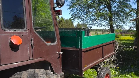 Old Vintage Brown Tractor with a Trailer Parked in Sunny Countryside Stock Footage 336652085