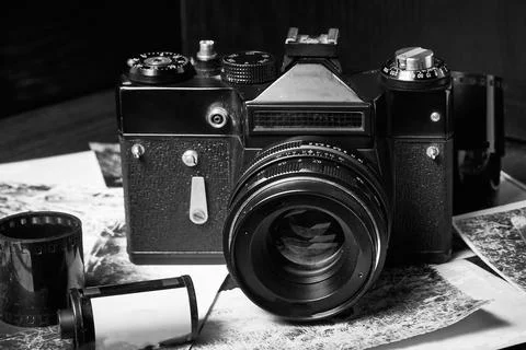 Old vintage camera, close-up, rolls of film, old photos, floating focus, black Stock Photos