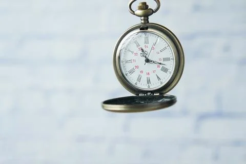 Old vintage clock against while wall Stock Photos
