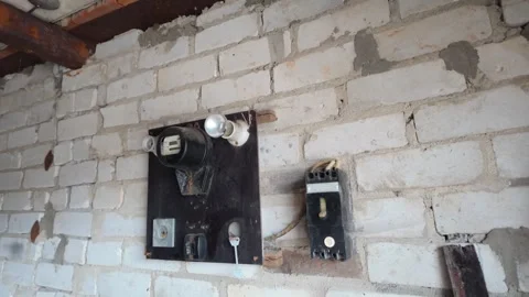 Old vintage electrical panel on a white brick wall Видео 335279432