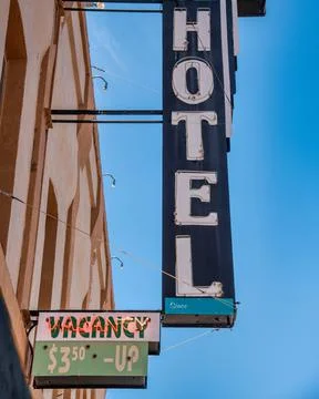 Old vintage hotel sign with vacancy and price notifications. Holiday and trav Stock Photos