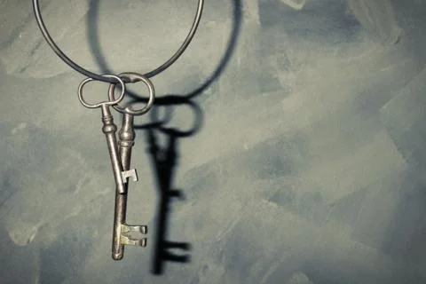 Old vintage key on rustic background Stock Photos