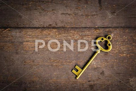 Old Vintage Key On Wood Texture Background With Space