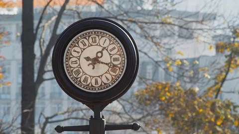 The old vintage round clock with black frame on the street Stock Footage 119760562