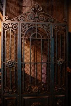 Old vintage rusty elevator gates in old mansion Stock Photos
