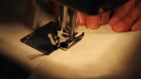 Old vintage sewing machine stitching on white fabric Video stock 84068389