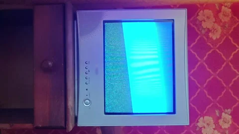 Old vintage TV showing static on a patterned red background Stock Footage 341410237