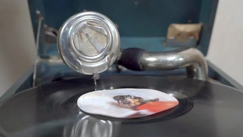 Old vinyl rotating disk is spinning with metal soundbox with rusty needle Stock Footage 159454487