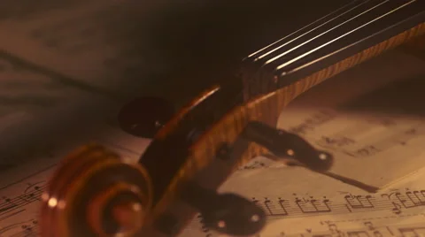 Old violin head with music notes background. Dolly shot Stock Footage 65413392