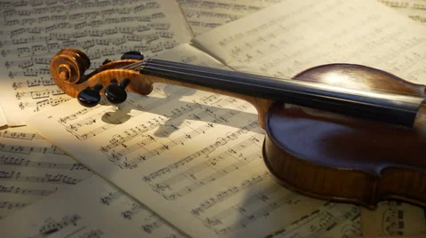 Old violin on musical notes background. Dramatic panorama shot Stock Footage 65412484
