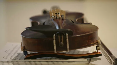 Old violin on musical notes book Stock Footage 50803054