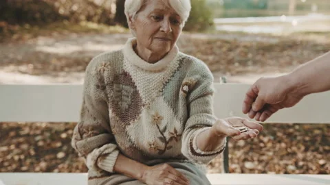 Old vulnerable lost or homeless woman getting coins. Dementia and mental issues Stock Footage 141220649