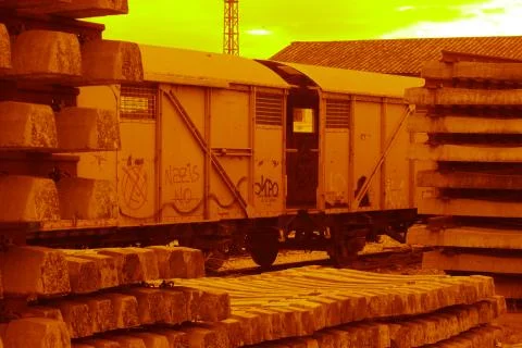 Old wagon of train abandoned between concrete beams Stock Photos
