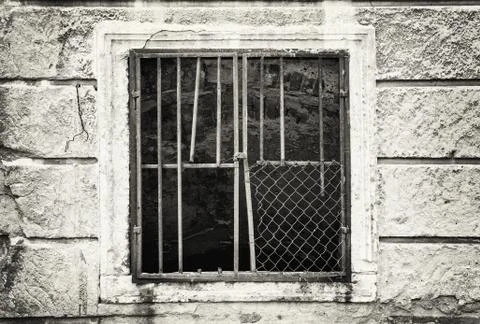 Old wall with barred window, black and white Stock Photos