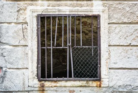 Old wall with barred window Stock Photos