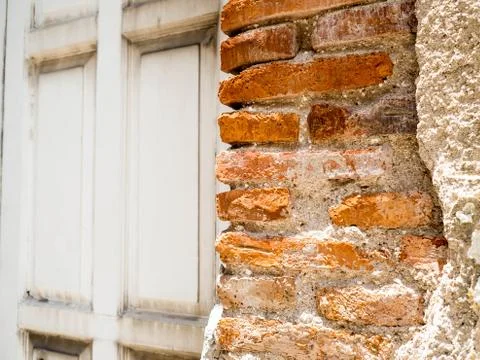 Old wall broken brick  see a orange brickwall inside. The side has old gray w 스톡 사진