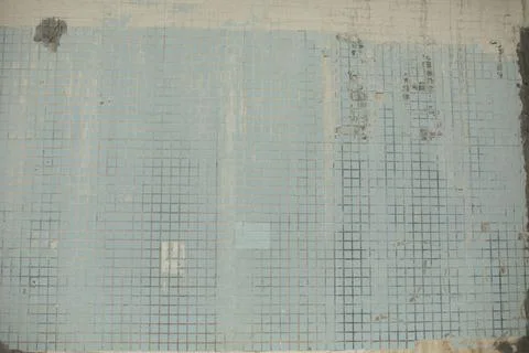 Old wall of building. Small tile wall. Tiles in cladding of building. Stock Photos