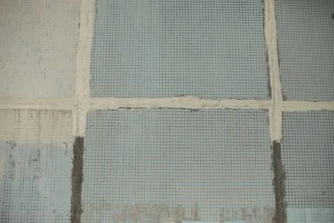 Old wall of building. Small tile wall. Tiles in cladding of building. Fotos de archivo