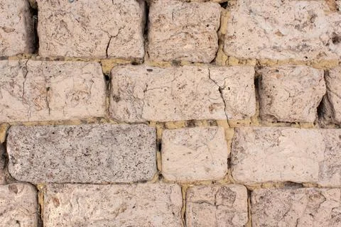 Old wall of clay blocks. Background of clay brickwork. Stock Photos