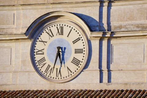 Old wall clock, side lighted in the afternoon Stock Photos
