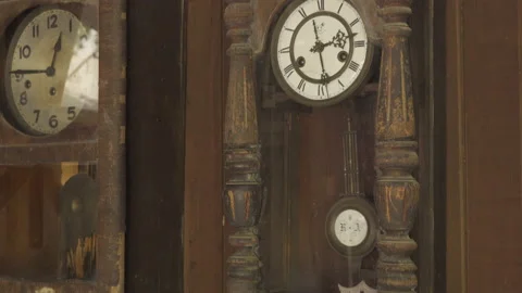 Old wall clock with a swaying pendulum Stock Footage 137087971