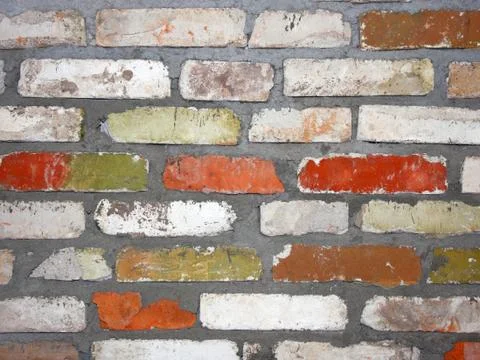 Old wall consisting of bricks of different color Foto stock