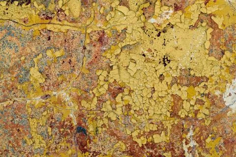 Old wall with falling off paint and plaster. A few cracks. Stock Photos