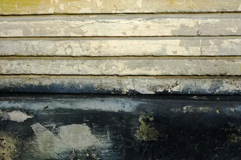 Old wall with horizontal decorative slits covered with paints with losses Stock Photos
