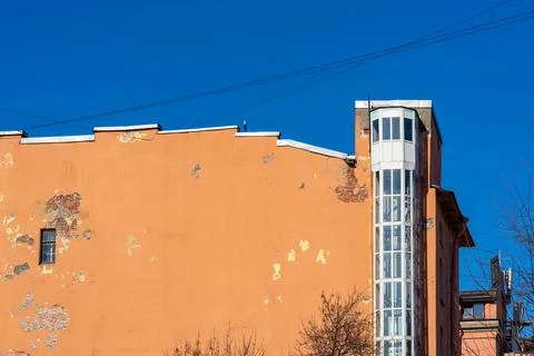 Old wall of the house with external arrangement of the elevator Stock Photos