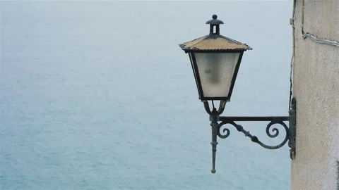 Old Wall Lantern On The House Corner On The Background Of Sea Water Surface Stock Footage 228116223