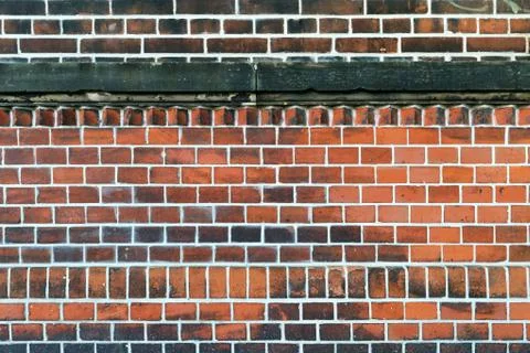 An old wall made of bricks with white interstice Stock Photos